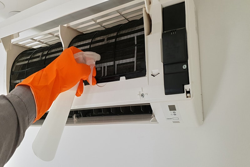 What Maintenance Is Needed for a Ductless System? Modern airconditioner unit service cleaning the filter to prevent respiratory disease.